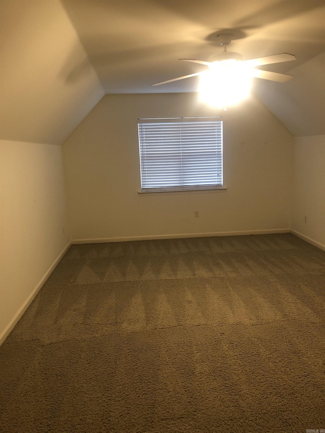 additional living space with ceiling fan, lofted ceiling, and carpet flooring