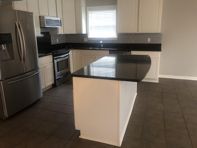 kitchen featuring sink, white cabinetry, backsplash, stainless steel appliances, and a kitchen island