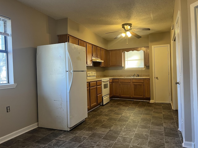 kitchen with ceiling fan, sink, a textured ceiling, and white appliances