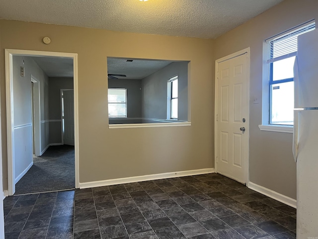 entryway with a textured ceiling