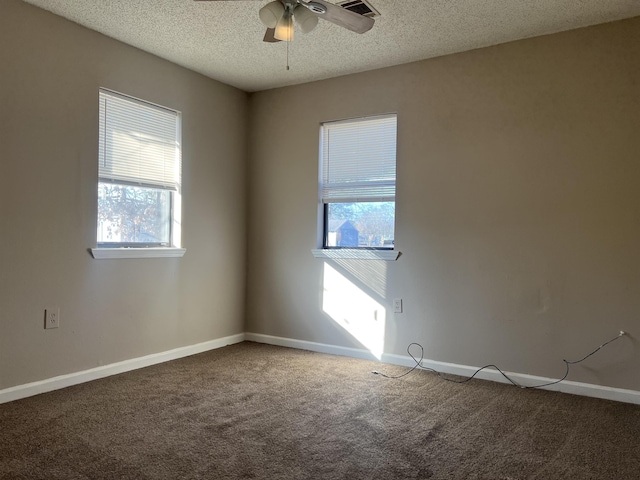 carpeted empty room with ceiling fan and a textured ceiling