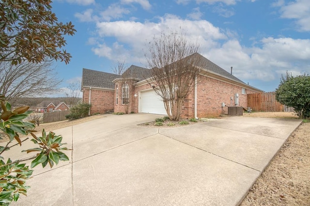 view of side of home with a garage and central AC unit