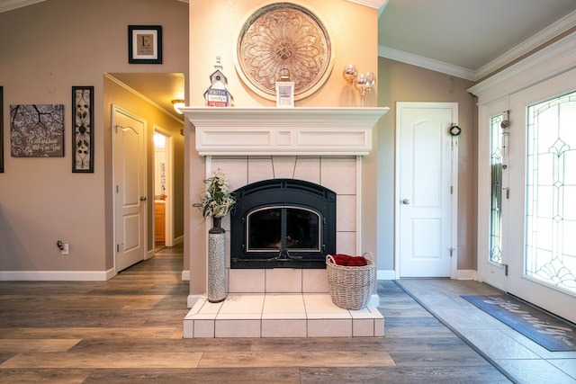 living room featuring lofted ceiling, crown molding, a fireplace, and hardwood / wood-style flooring