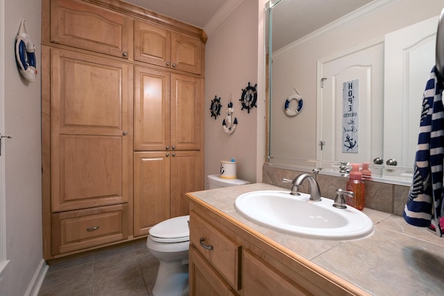 bathroom with vanity, tile patterned flooring, crown molding, and toilet