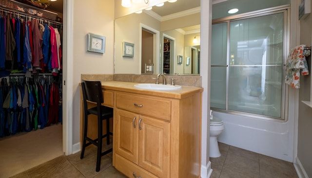 full bathroom featuring toilet, crown molding, shower / bath combination with glass door, vanity, and tile patterned flooring