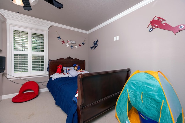 carpeted bedroom featuring crown molding and ceiling fan