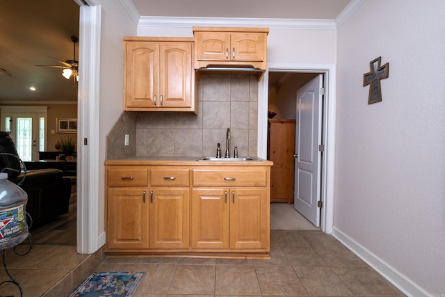 kitchen featuring crown molding, sink, and tasteful backsplash