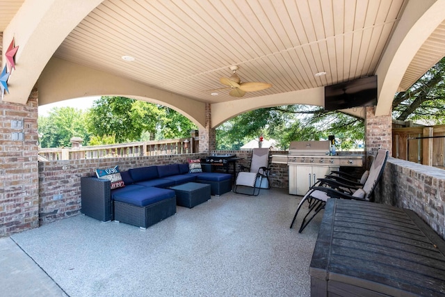 view of patio / terrace featuring a grill, an outdoor living space, ceiling fan, and exterior kitchen