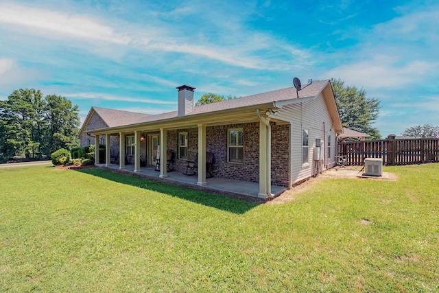 back of property featuring central AC, a lawn, and a patio