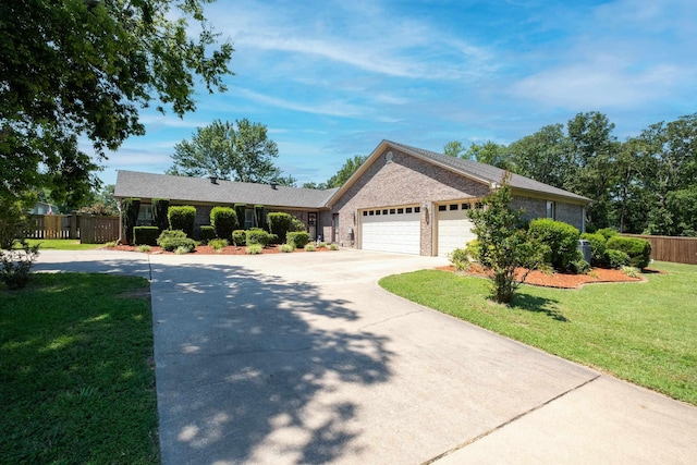 single story home featuring a garage and a front yard