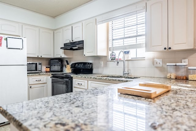 kitchen featuring black electric range oven, sink, light stone counters, white cabinets, and white fridge