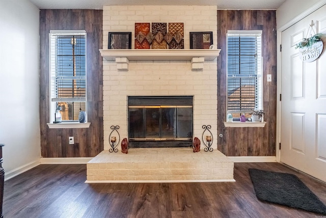 details with wood-type flooring, a brick fireplace, and wood walls