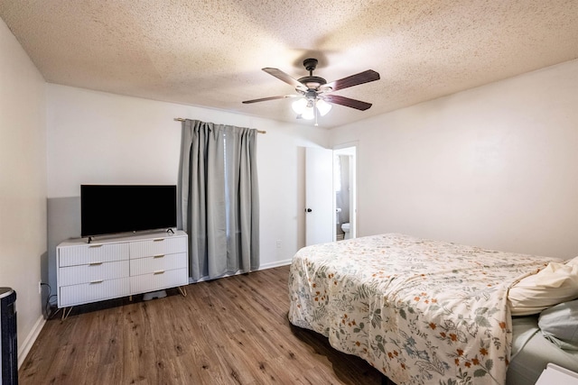 bedroom featuring ceiling fan, wood-type flooring, and a textured ceiling