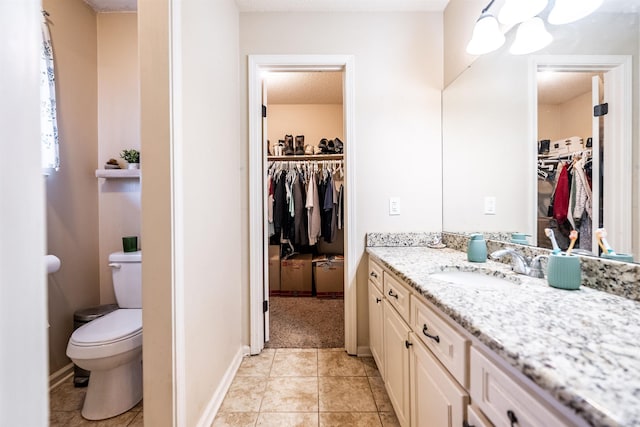 bathroom with tile patterned floors, vanity, and toilet