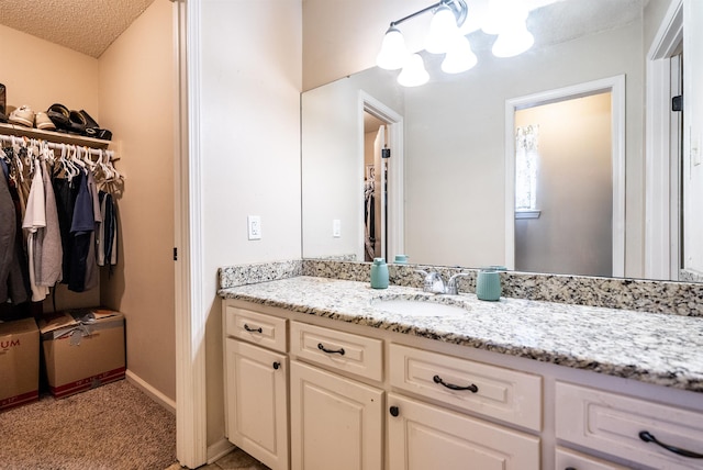 bathroom featuring vanity and a textured ceiling