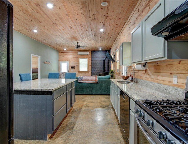 kitchen featuring range hood, light stone countertops, black appliances, and sink