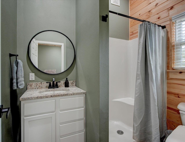 bathroom featuring vanity, toilet, and walk in shower