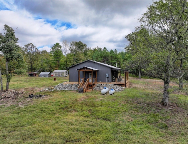 exterior space featuring an outbuilding and a lawn