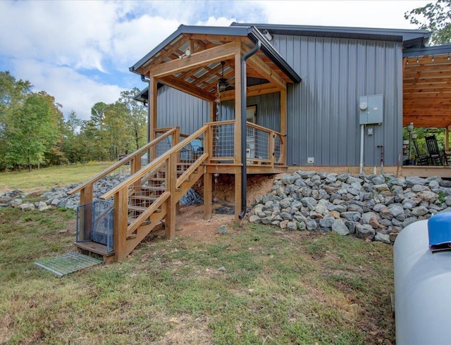 exterior space with a yard and ceiling fan