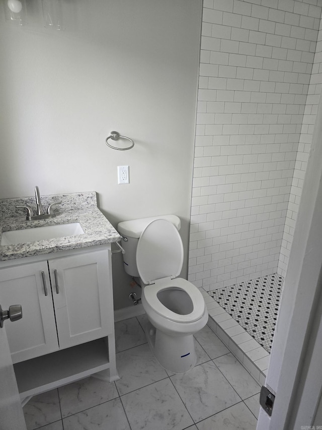bathroom with a stall shower, marble finish floor, vanity, and toilet