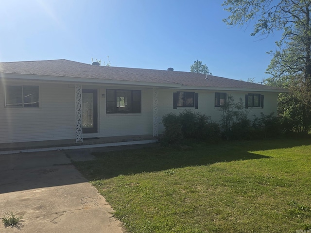 ranch-style home with covered porch and a front yard