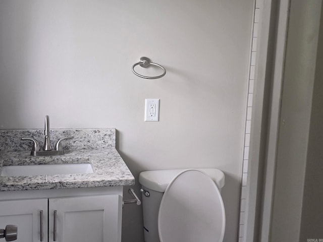 bathroom featuring toilet and vanity