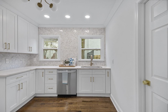 kitchen featuring sink, dark wood-type flooring, white cabinetry, backsplash, and stainless steel dishwasher