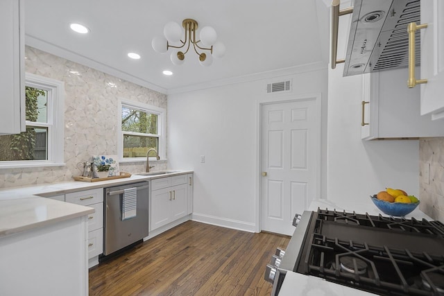 kitchen featuring sink, dark wood-type flooring, appliances with stainless steel finishes, white cabinetry, and decorative backsplash