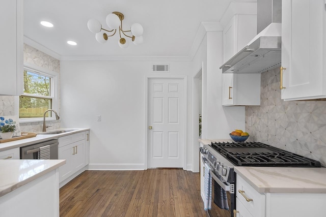 kitchen featuring white cabinetry, sink, stainless steel appliances, crown molding, and wall chimney exhaust hood