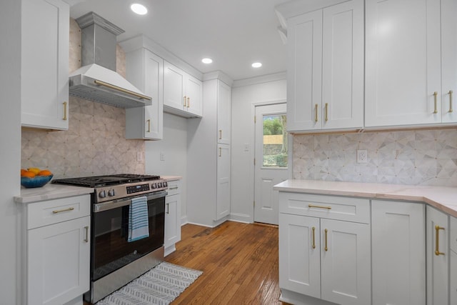 kitchen with white cabinets, custom exhaust hood, and stainless steel gas stove