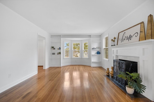 living room featuring hardwood / wood-style floors and built in features