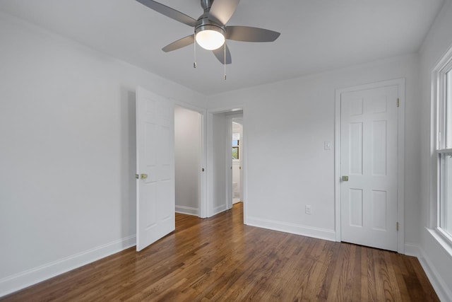 spare room with dark hardwood / wood-style floors and ceiling fan