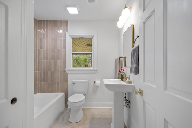 bathroom with tile patterned floors, toilet, and shower / bath combination