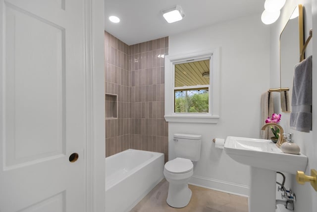 bathroom featuring tiled shower / bath and toilet