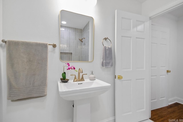 bathroom with sink and a tile shower