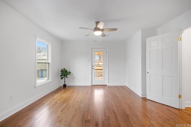 unfurnished room featuring plenty of natural light, hardwood / wood-style floors, and ceiling fan