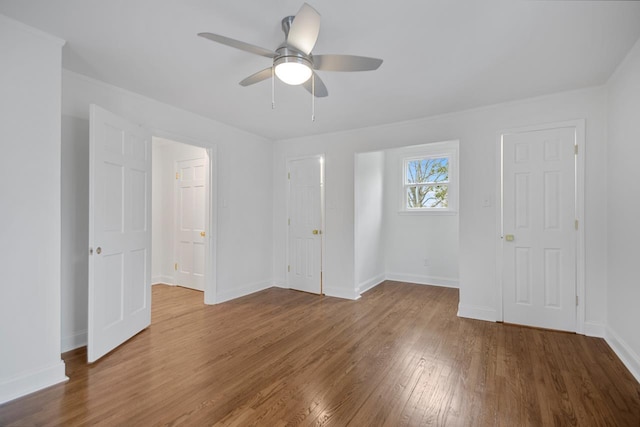 empty room with wood-type flooring and ceiling fan