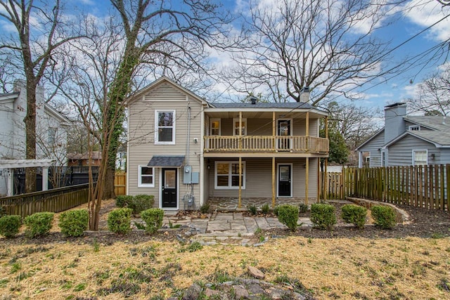 rear view of property featuring a balcony