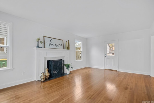 unfurnished living room featuring light hardwood / wood-style floors