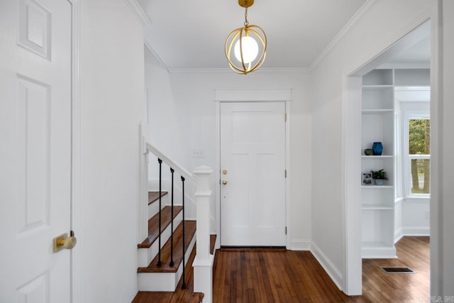 entryway featuring crown molding and dark hardwood / wood-style floors