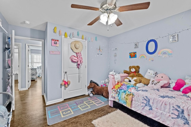 bedroom featuring ceiling fan and dark hardwood / wood-style floors