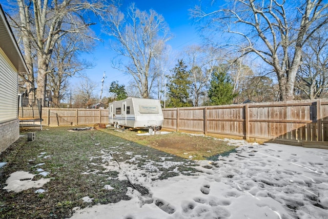 yard covered in snow featuring a trampoline