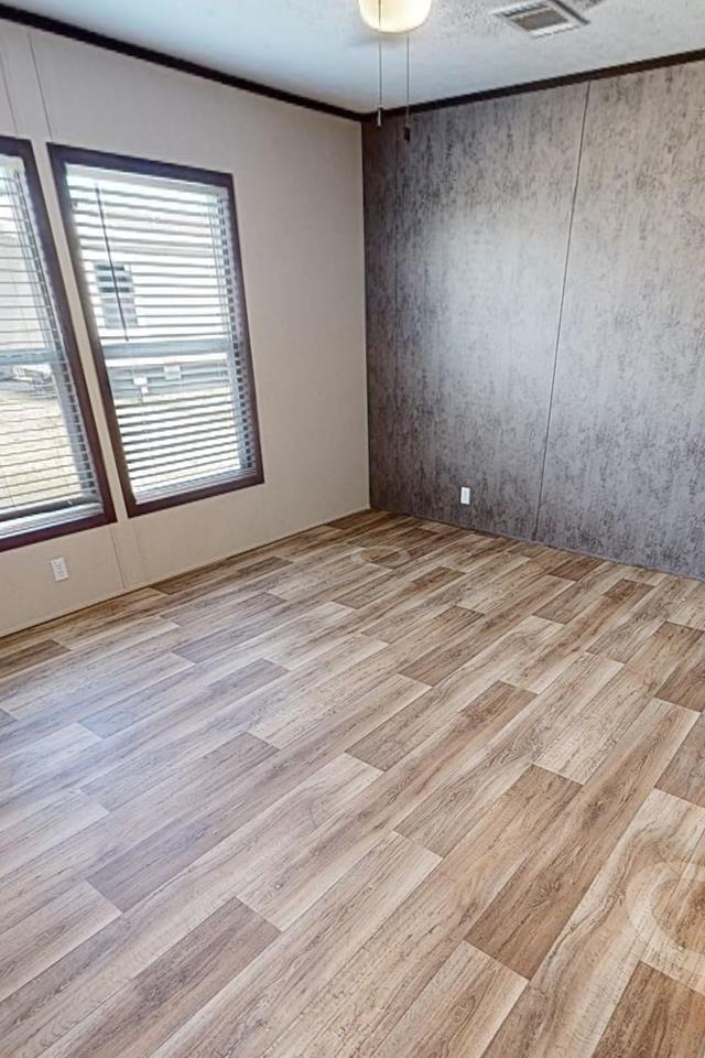 spare room with light wood-style floors