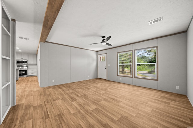 unfurnished living room with light wood-style floors, a ceiling fan, and a textured ceiling