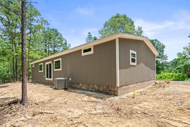 view of side of home with central AC