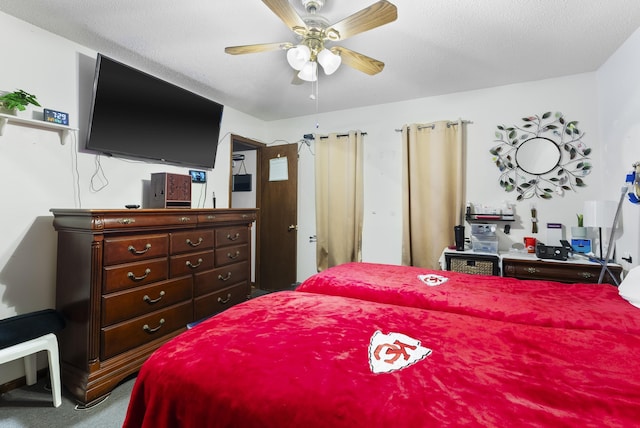 bedroom featuring ceiling fan, carpet, and a textured ceiling