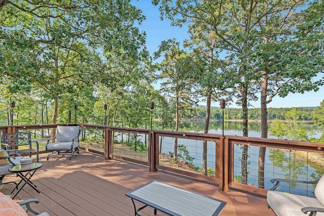 wooden terrace featuring a water view