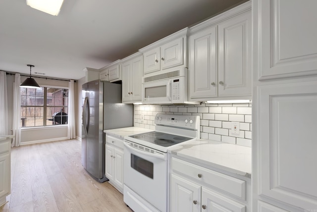 kitchen featuring white cabinetry, backsplash, light stone counters, light hardwood / wood-style floors, and white appliances