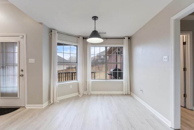 unfurnished dining area with light hardwood / wood-style flooring