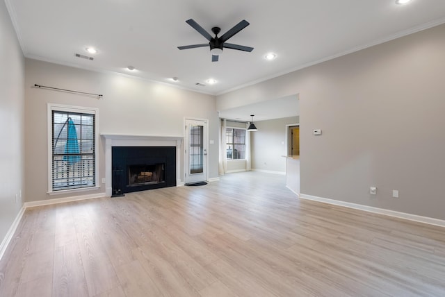 unfurnished living room featuring crown molding, ceiling fan, and light hardwood / wood-style floors